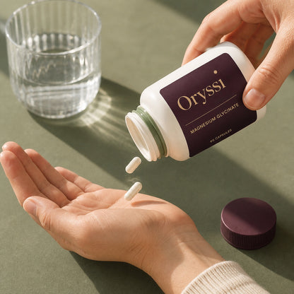 Oryssi magnesium glycinate capsules poured from the bottle into an open palm